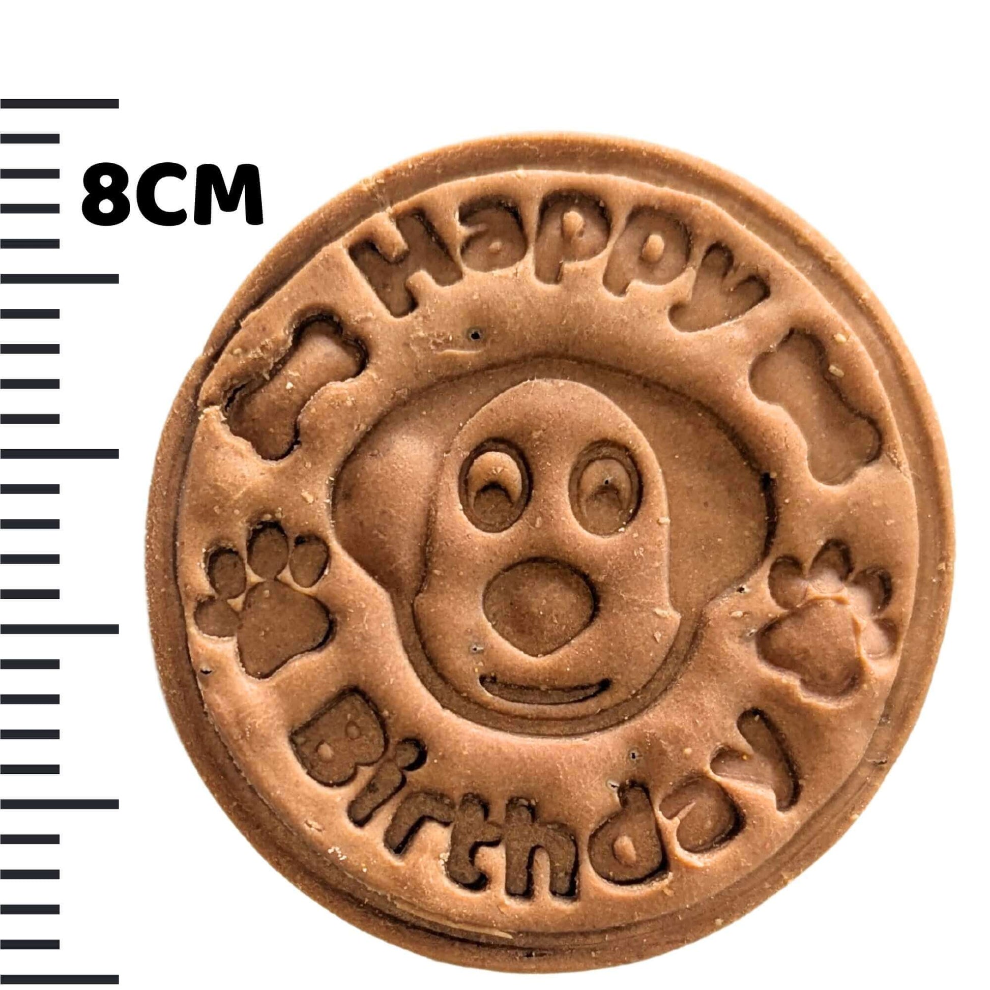 dog birthday biscuits with measuring tape